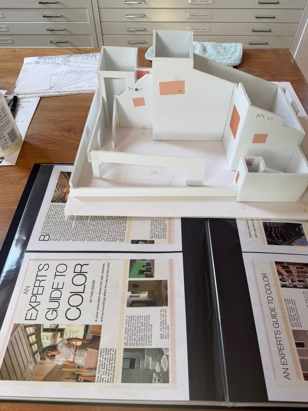 The model is next to a 1976 article about Tina’s work.